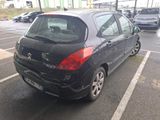 a small black car parked in a parking lot