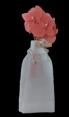 a small bag with flowers in it on a black background
