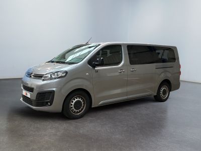 the silver van is parked in a room with a white wall