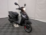 a scooter that is parked on a checkered floor