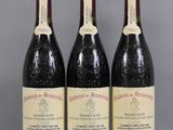 three bottles of wine are lined up on a table