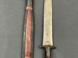 two knives are sitting next to each other on a table