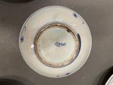 a white plate with a blue and white design on it