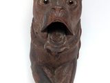 an image of a statue of a bear with a knife in its mouth