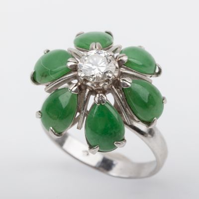 an image of a ring with green and white stones and a diamond