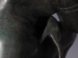 statue of a man with a horse ' s head in his hands