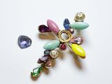 une photo d'une broche ornée d'un bouquet de perles