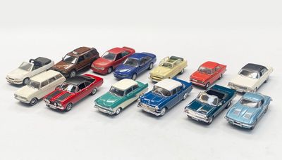 several toy cars are lined up in a row on a white surface