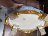 a blue and white vase with gold decoration on it