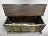 a wooden chest with a chain hanging from it ' s sides