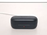 a small black device sitting on a white surface