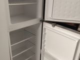 a white refrigerator with its door open in a kitchen