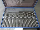 silverware in a blue case sitting on top of a table