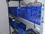 many blue baskets on the shelves in the room