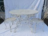 a white table and four chairs on a white cloth