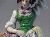 a figurine of a woman with a basket on her head