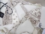 a white shirt with a bandana on it and a pair of glasses