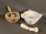 mortar and mortar set on a table with a wooden spoon