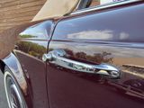 a close up of a car door handle on the side of the road