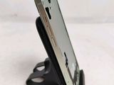 a close up of a cell phone on a stand on a table