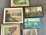 many paintings on the floor of this room