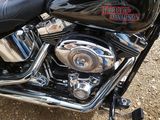 a black motorcycle that is parked in the dirt