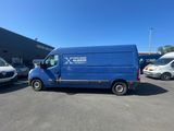 a blue van parked in a parking lot next to other vans