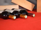 several bottles of wine are lined up on a red table