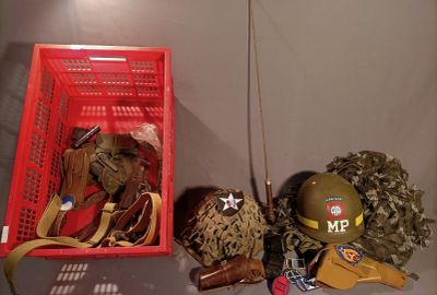 a red basket filled with assorted items sitting on a table