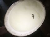 a close up of a white vase with the letter p on it