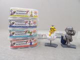 toy figurines of a man sitting on a chair next to a stack of boxes