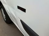 a close up of a white car with a sticker on it