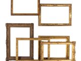a set of four gold picture frames on a white background
