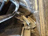 a close up of a car ' s engine with a hose attached to it