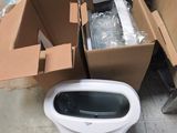 a toilet that is sitting on the ground next to a box