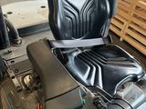 a black seat on a forklift in a warehouse