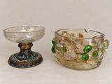 two glass bowls sitting next to each other on a table