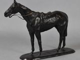 statue of a black horse with a saddle on a black base
