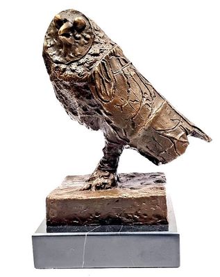 a statue of a bird that is sitting on top of a base