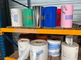 many rolls of toilet paper on a shelf in a warehouse