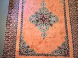 an orange rug with a cross design on it