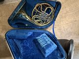 a blue case with a brass instrument inside of it