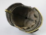 a metal object that is sitting on a white surface