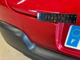 a sticker on the back of a red car