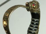 a close up of a sword with a lion head on it