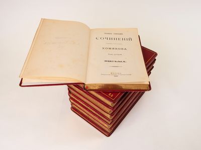 several books stacked on top of each other on a white surface