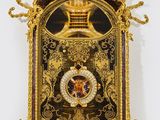 an image of a gold clock with a crown on top of it