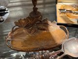 a display of antique silverware on a glass table