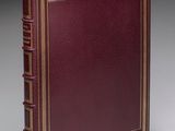un livre en cuir rouge avec des finitions dorées et une bordure dorée