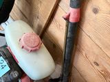 a picture of a gas can and a blower in a room